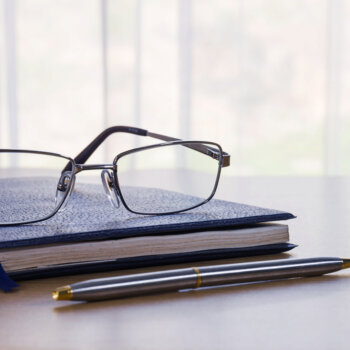 glasses on top of legal documents